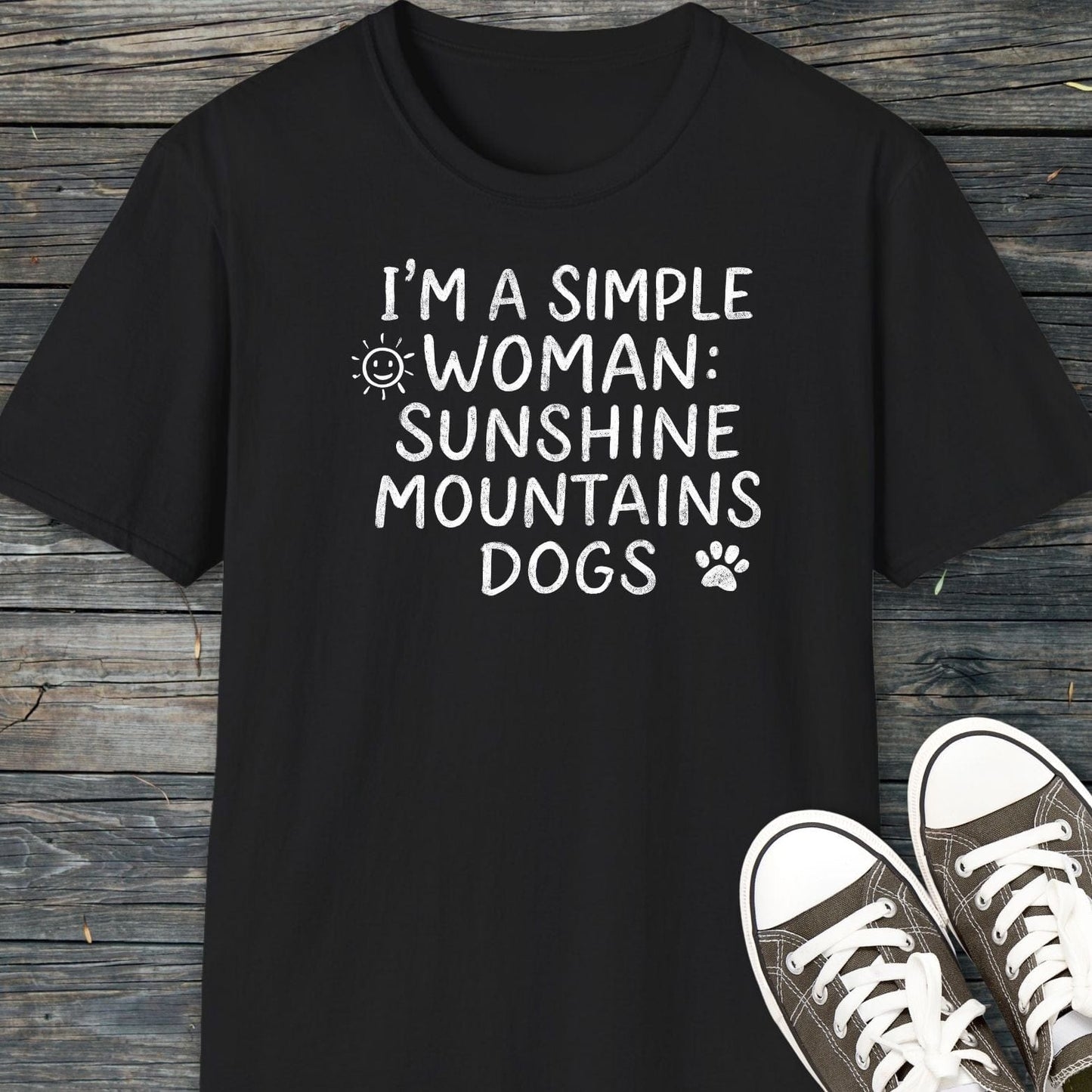 Sunshine Mountains Dogs T-Shirt shown flat-lay with canvas sneakers, featuring white hand-lettered text and graphics on black, highlighting comfort and outdoor-themed design.