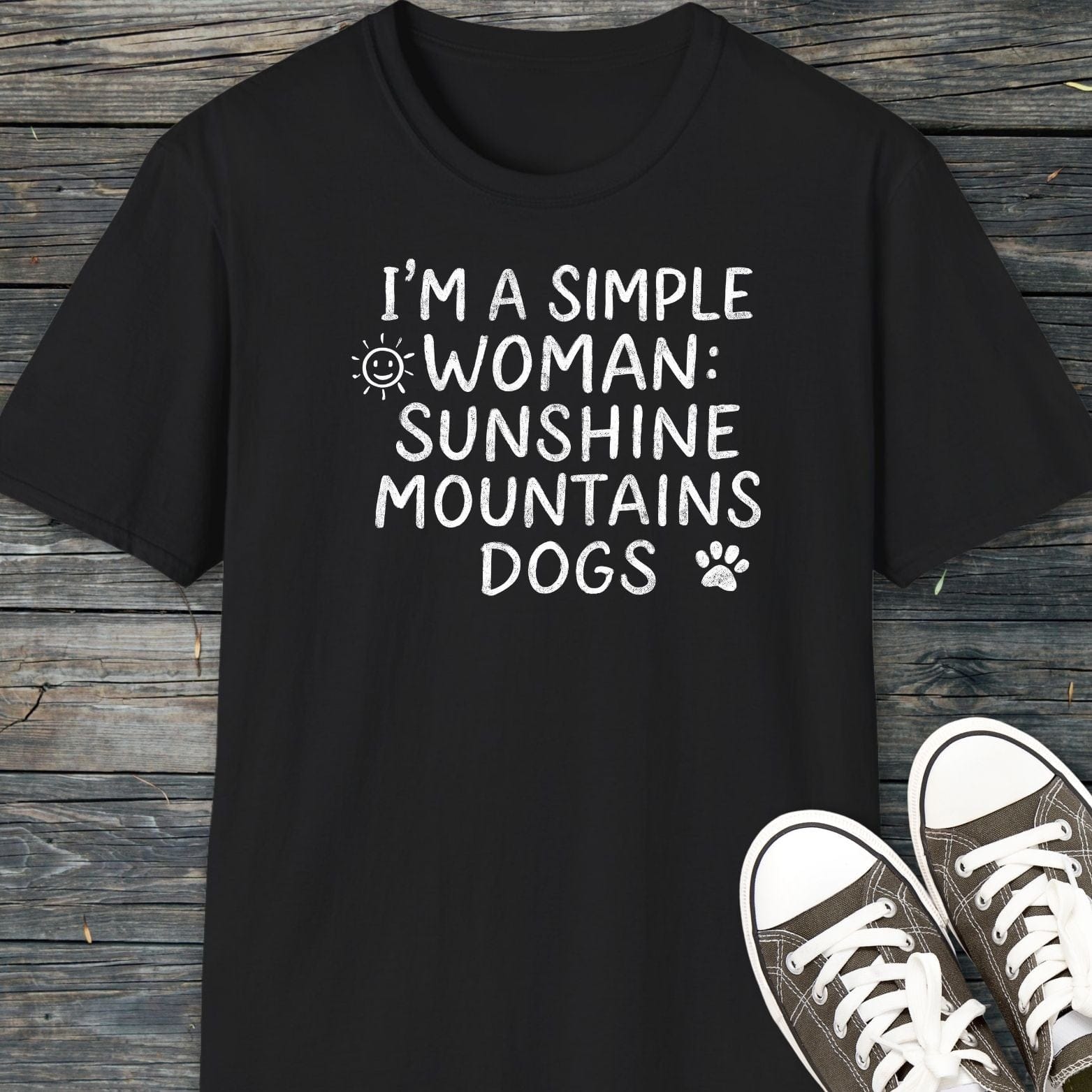 Sunshine Mountains Dogs T-Shirt shown flat-lay with canvas sneakers, featuring white hand-lettered text and graphics on black, highlighting comfort and outdoor-themed design.