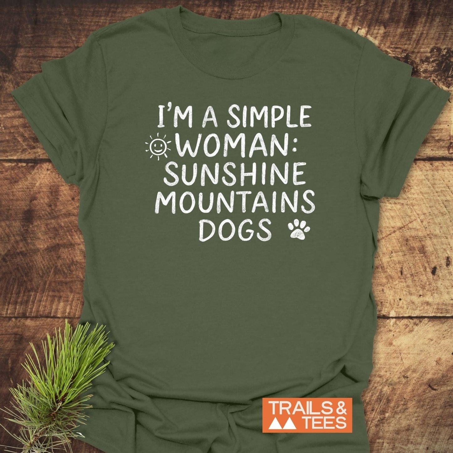 Sunshine Mountains Dogs T-Shirt in forest-green with white slogan and sun, paw print icons; soft cotton, pre-shrunk, durable print, Trails & Tees logo.