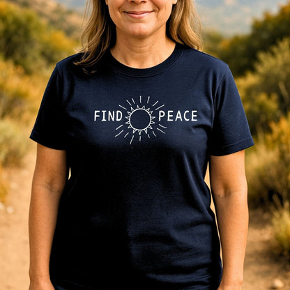 Person wearing the Find Peace T-Shirt with FIND and PEACE text separated by a sun graphic, designed for comfort and outdoor adventures.