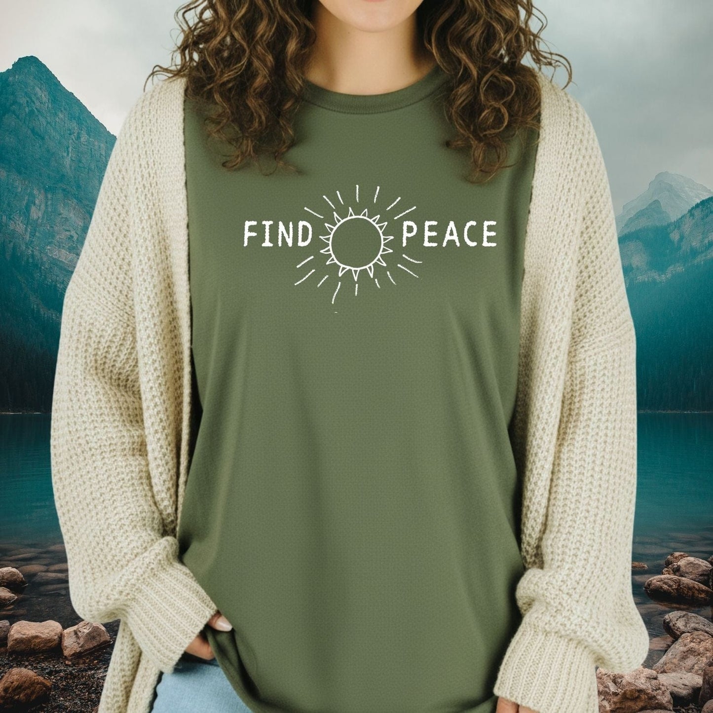Find Peace T-Shirt shown with a sun icon and FIND PEACE text, worn over a knit cardigan, embodying comfort and outdoor adventure spirit.