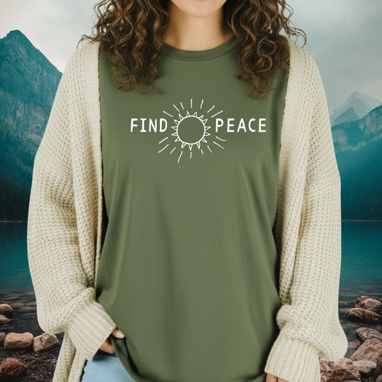 Find Peace T-Shirt shown with a sun icon and FIND PEACE text, worn over a knit cardigan, embodying comfort and outdoor adventure spirit.