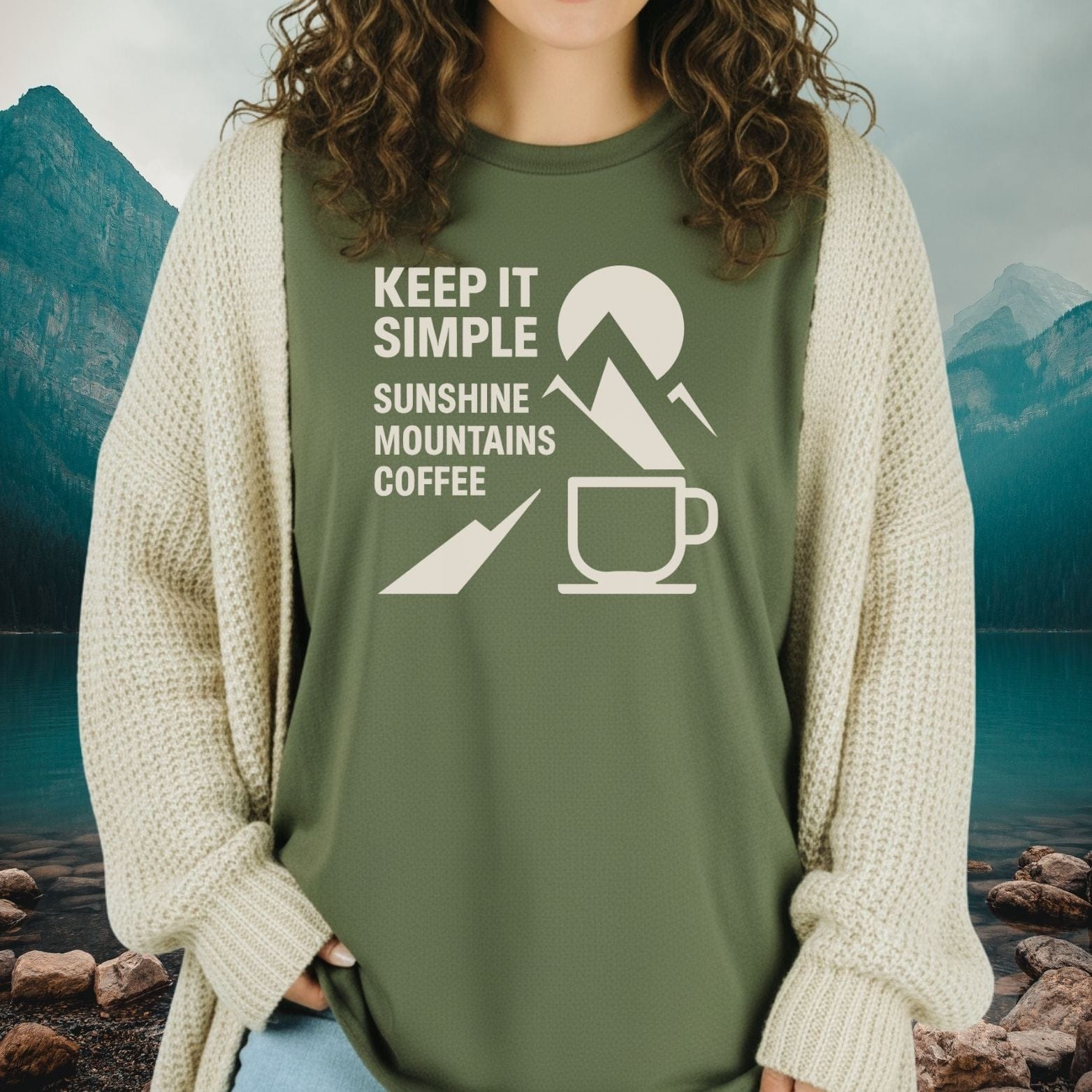 Person wearing Keep It Simple Mountain T-Shirt with outdoor-themed print under cream cardigan, embodying comfort and adventure-ready style.