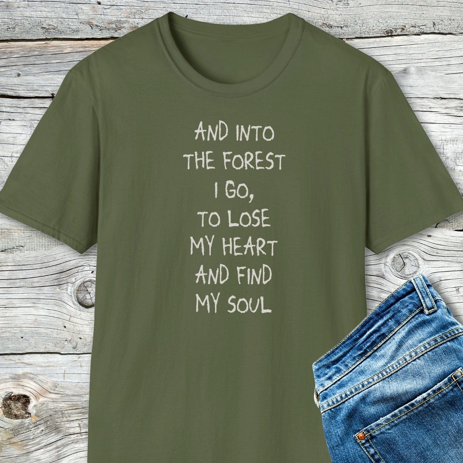 And Into The Forest I Go T-Shirt in olive-green with hand-lettered text, paired with blue jeans, showcasing soft, lightweight, durable cotton for comfort and adventure.