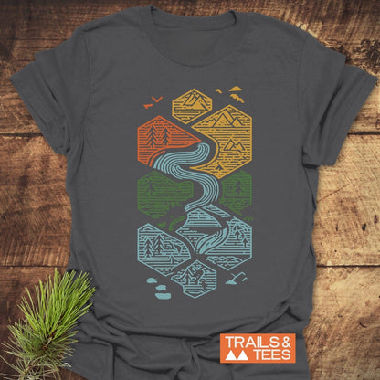 Everything Flows T-Shirt: Charcoal-gray tee with hexagonal nature designs, featuring mountains and rivers. Soft cotton, pre-shrunk, durable print, ideal for outdoor enthusiasts.