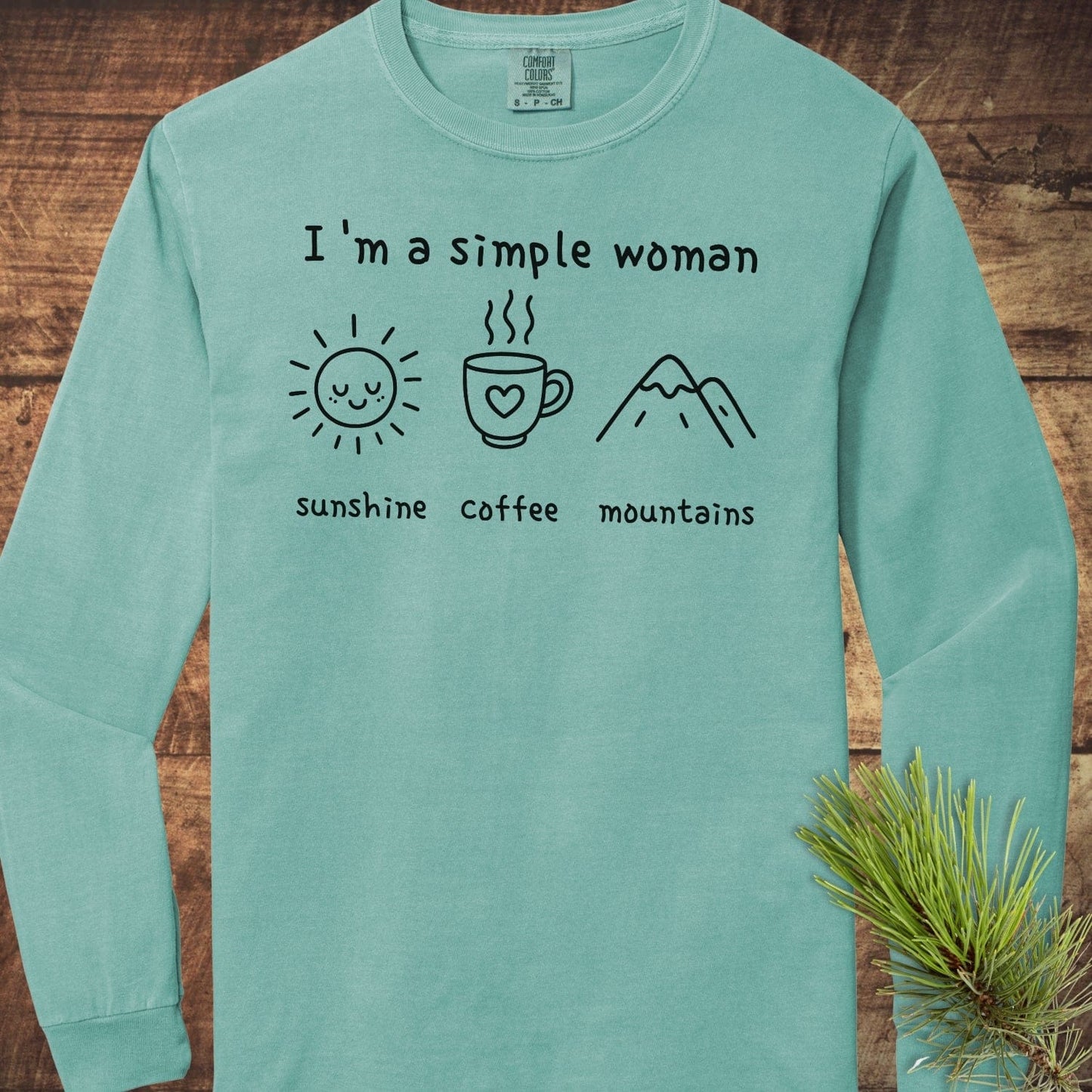 I'm A Simple Woman Comfort Colors Long-Sleeve Tee featuring a sunshine, coffee, and mountains print, laid flat with a relaxed fit for casual comfort.