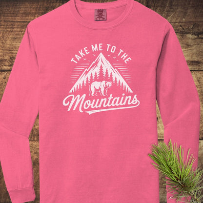 Copy of Mountain Energy Comfort Colors Long-Sleeve Tee featuring a vintage mountain graphic and bear, laid flat with pine needles on the side.