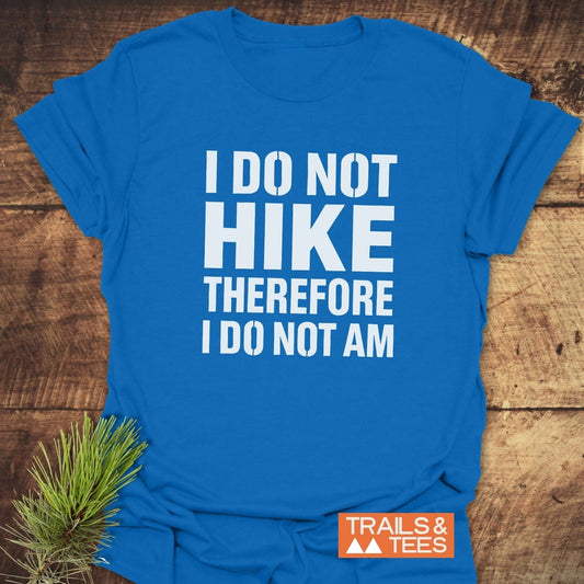 I Do Not Hike Funny T-Shirt on wood, featuring bold white text, small TRAILS & TEES logo, pine sprig, highlighting comfort and durability for outdoor enthusiasts.