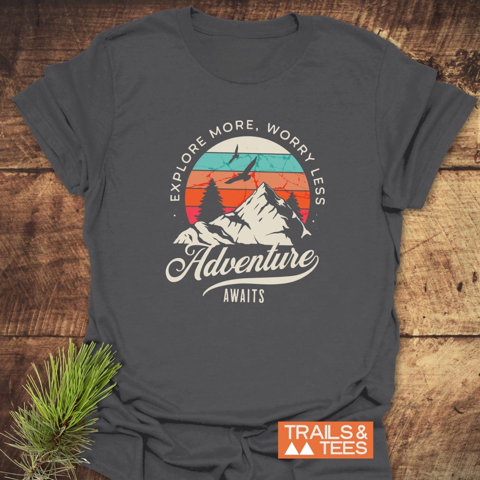 Adventure Awaits Retro T-Shirt with mountain and sunset graphic, encouraging exploration. Made from soft, lightweight cotton for comfort and durability, perfect for outdoor enthusiasts.