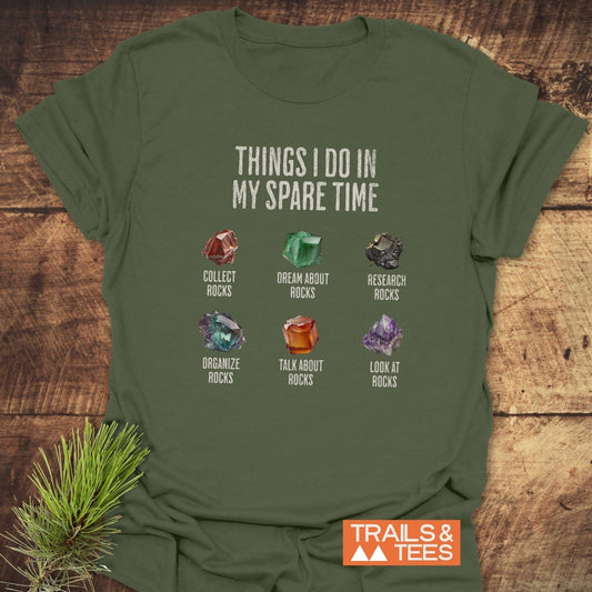 Sparetime Rock Lover T-Shirt with six rock-themed activities and illustrations on the chest, featuring a TRAILS & TEES logo in the corner.