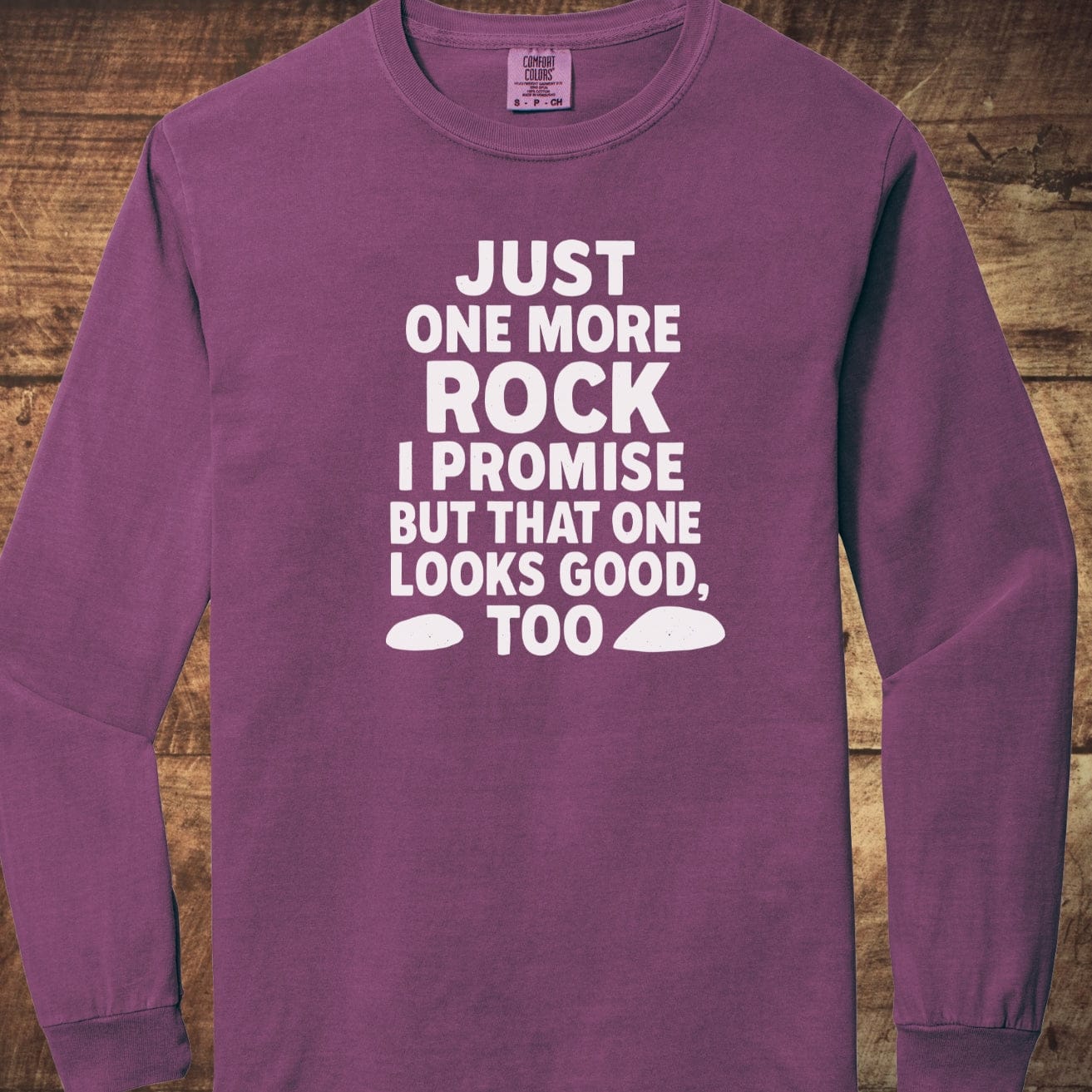 Just One More Rock Comfort Colors Long-Sleeve Tee featuring a humorous slogan and rock silhouettes, displayed flat with a focus on its soft, relaxed fit.