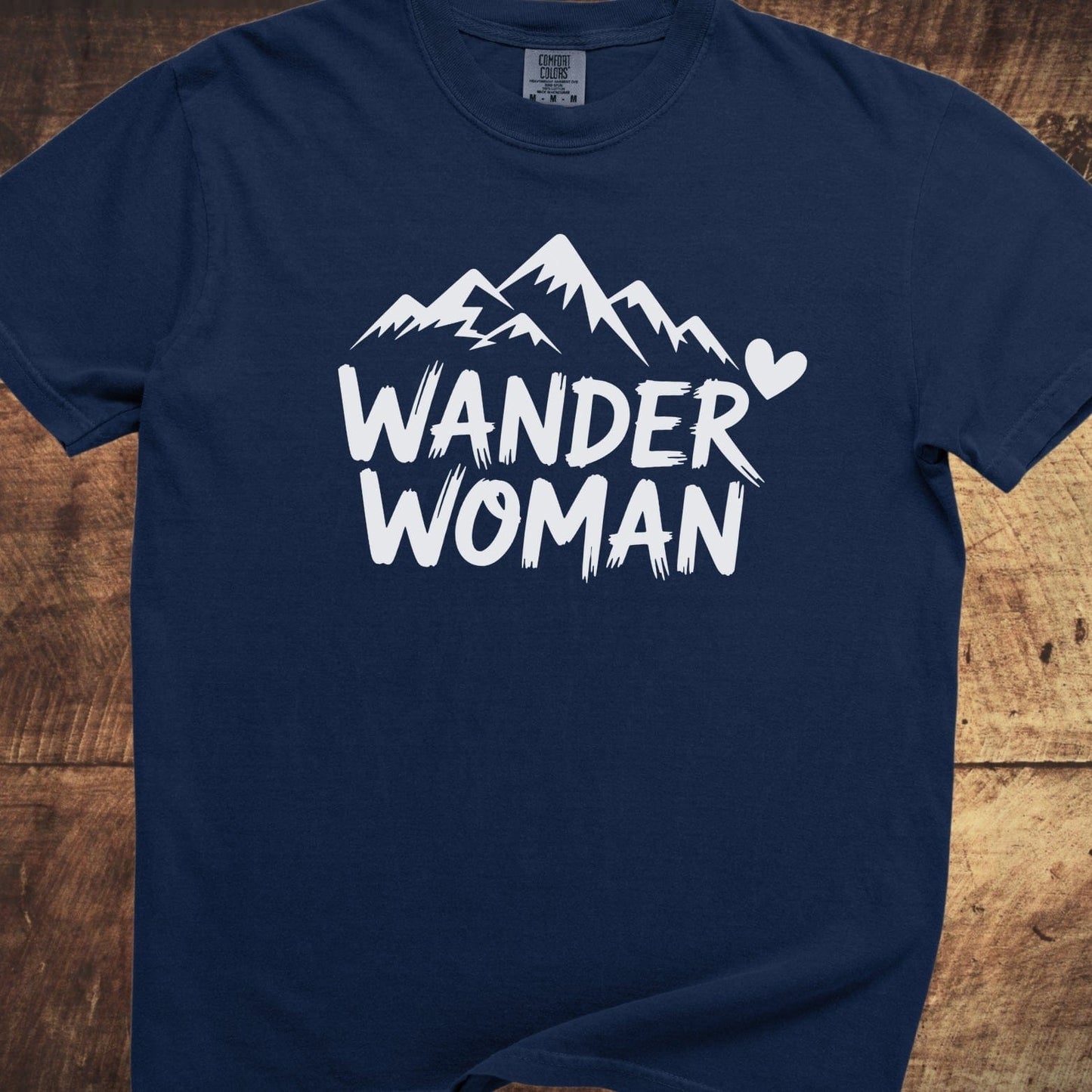 Wander Woman Comfort Colors 1717 Tee with jagged mountain graphic and heart. Navy-blue, garment-dyed, ring-spun cotton, relaxed fit, durable stitching.