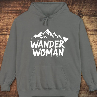 Wander Woman Comfort Colors Hoodie features a mountain graphic and “WANDER WOMAN” text, relaxed fit, kangaroo pocket, ideal for trail adventures and cozy nights.