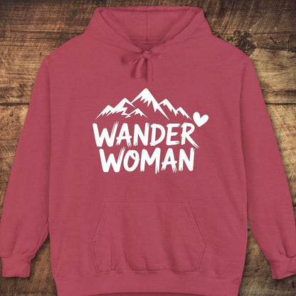 Wander Woman Comfort Colors Hoodie with mountain peak graphic, heart, and brush-style text. Features kangaroo pocket, jersey-lined hood, and relaxed unisex fit for comfort.