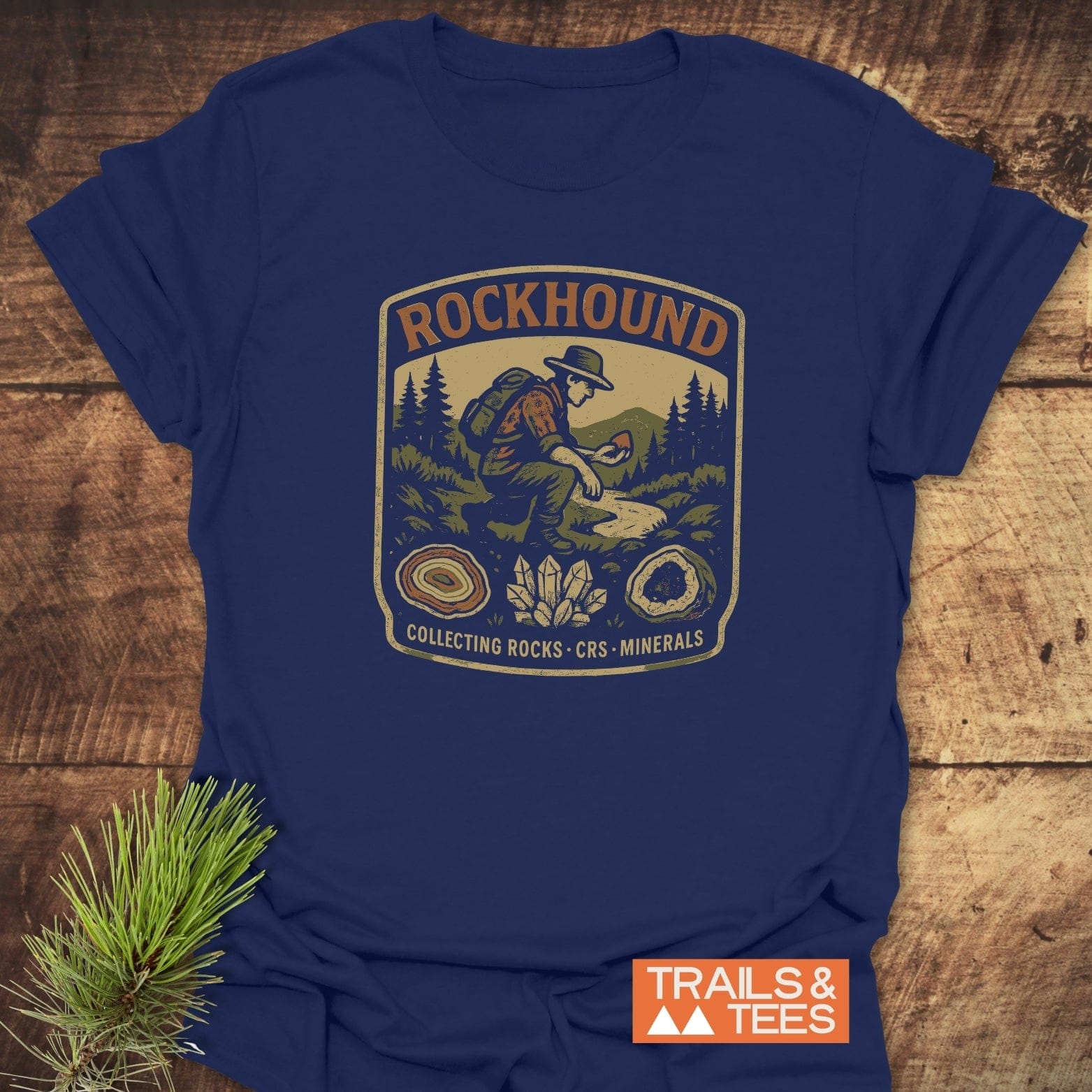 Rockhound Badge T-Shirt featuring vintage graphic of a rock collector in a mountain scene, crafted from soft cotton, highlighting geodes and quartz illustrations.