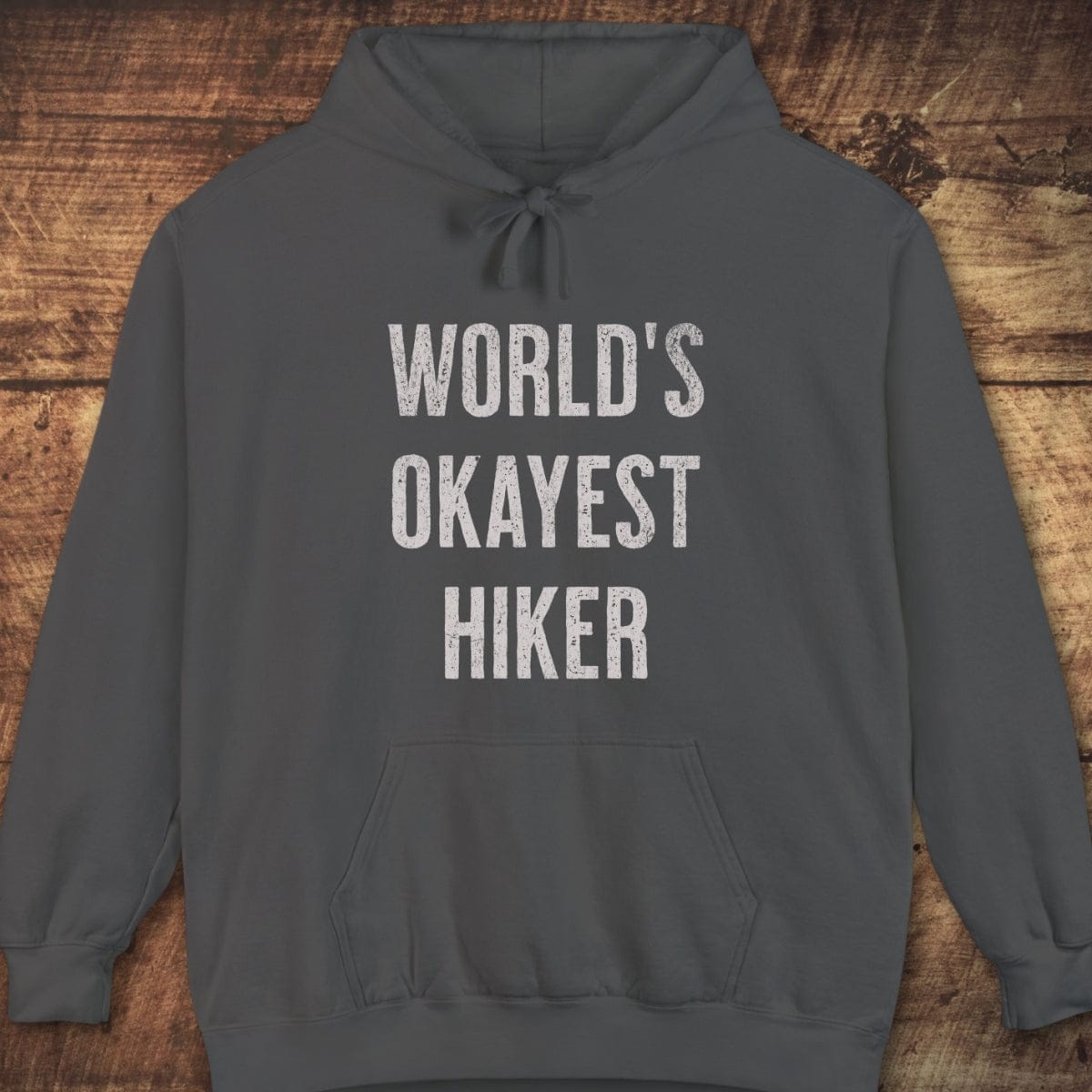 World's Okayest Hiker Comfort Colors Hoodie, dark-gray with weathered white print, unisex fit, jersey-lined hood, front pocket, garment-dyed for a vintage feel.