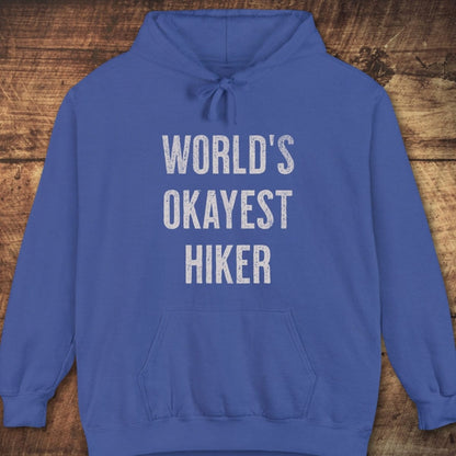 World's Okayest Hiker Comfort Colors Hoodie, featuring distressed white text, jersey-lined hood, front pouch pocket, and relaxed unisex fit, ideal for outdoor adventures.