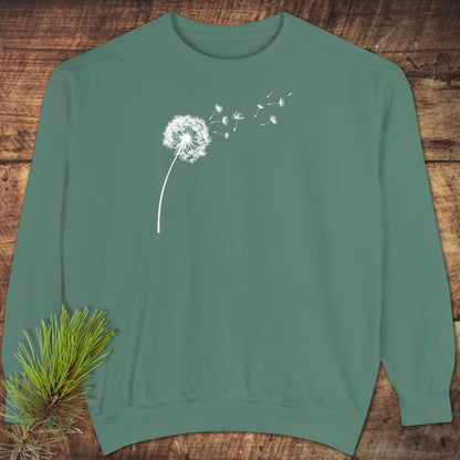 Dandelion Comfort Colors Sweatshirt displayed on wood, showcasing a white dandelion design, highlighting its relaxed fit and premium, ring-spun cotton-polyester blend.