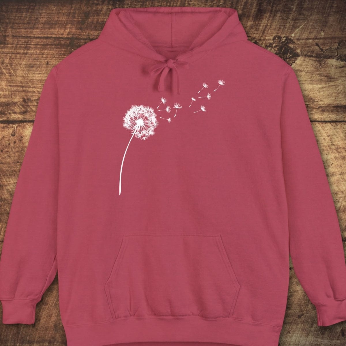 Dandelion Comfort Colors Hoodie: Pullover with white dandelion graphic, drawstring hood, and kangaroo pocket, showcasing relaxed fit and vintage garment-dyed texture.