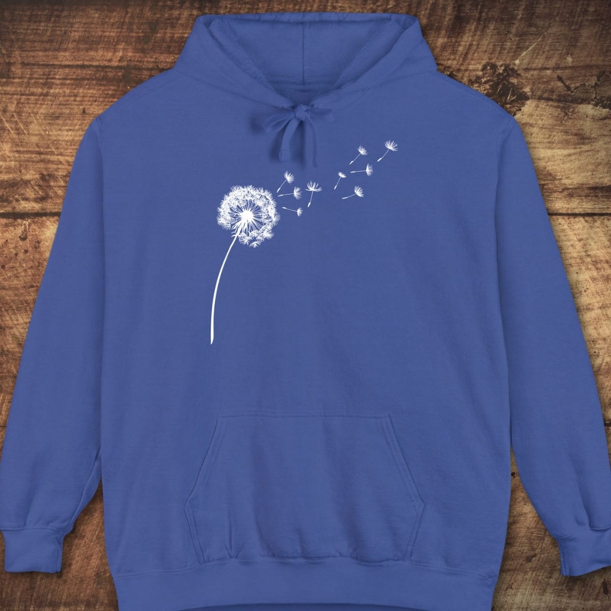 Dandelion Comfort Colors Hoodie with a stylized dandelion graphic, kangaroo pocket, and ribbed cuffs, offering a relaxed unisex fit and vintage garment-dyed look.