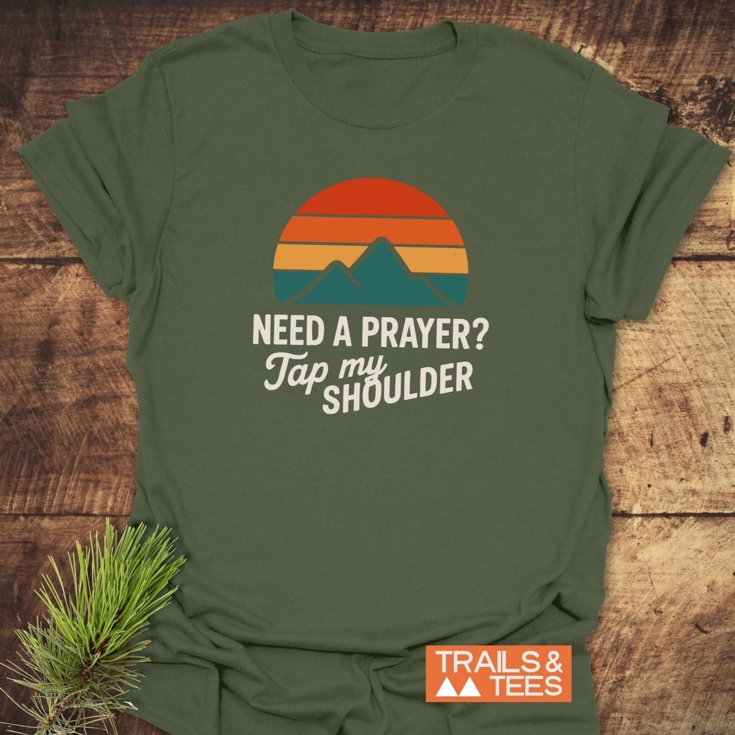 Tap My Shoulder Mountain T-Shirt with retro sunset and peaks graphic, featuring NEED A PRAYER? Tap my SHOULDER. Logo: TRAILS & TEES.