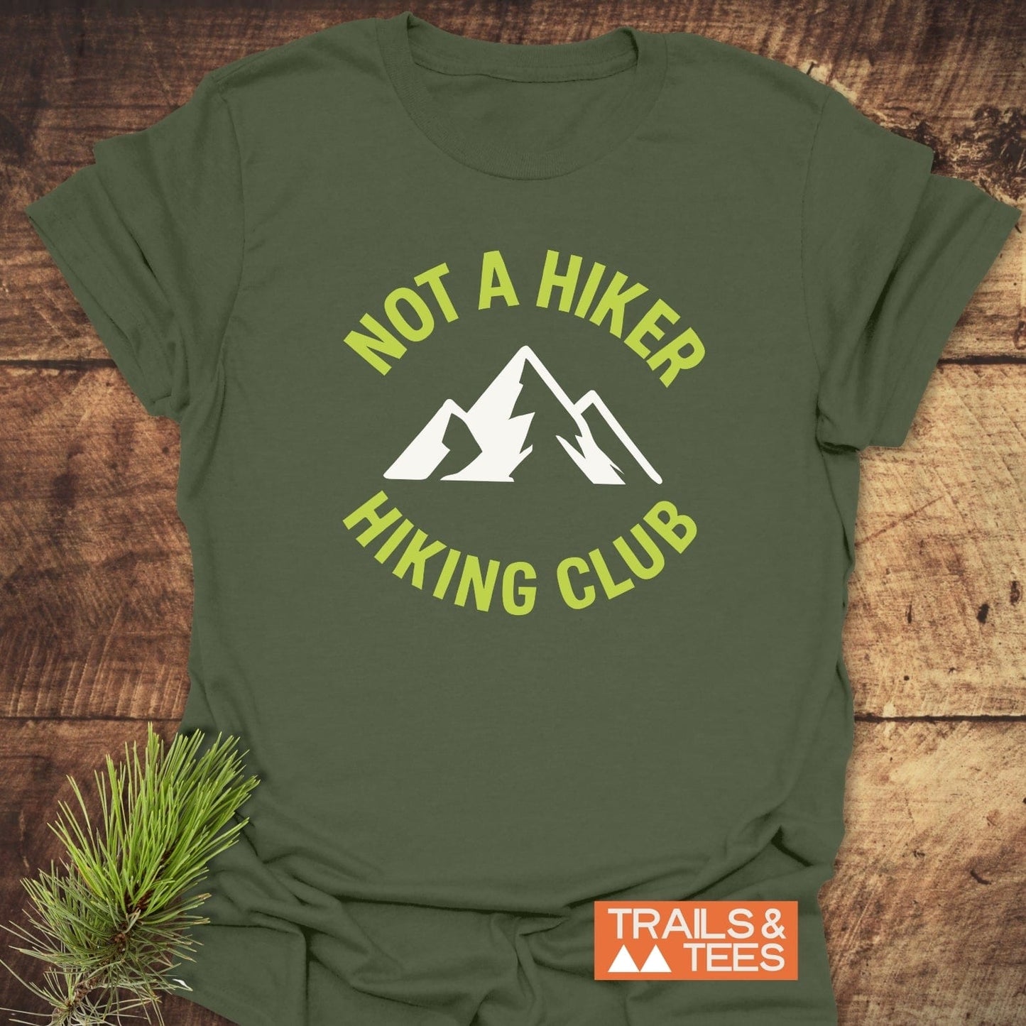 Not A Hiker T-Shirt with mountain graphic, highlighted by “HIKING CLUB” text, captures outdoor spirit. Features soft, durable cotton for adventure-ready comfort.