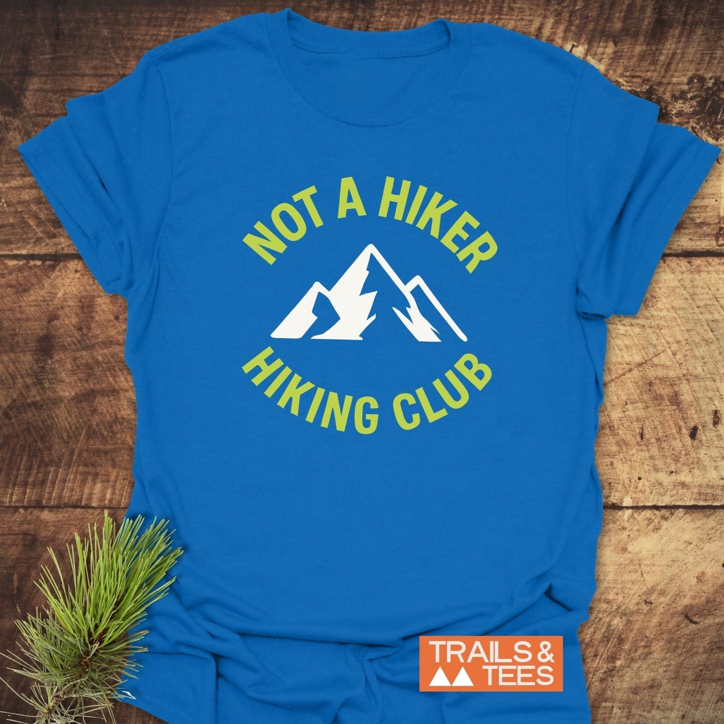 Not A Hiker T-Shirt with a white mountain graphic, chartreuse lettering, and “TRAILS & TEES” logo, crafted for comfort and durability from lightweight ring-spun cotton.
