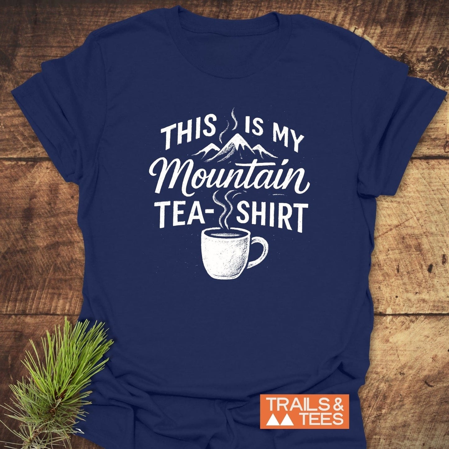 Mountain Tea T-Shirt features a steaming mug and mountains graphic with the slogan, “This Is My Mountain Tea-Shirt,” reflecting outdoor adventure and comfort.