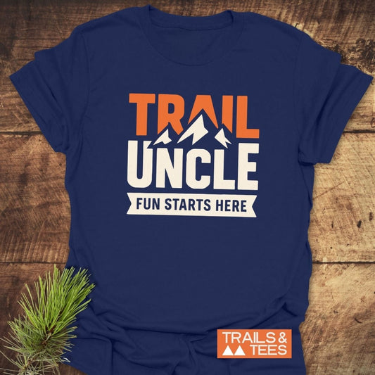 Navy-blue Trail Uncle Funny T-Shirt with bold orange and white print on a wooden surface, showcasing casual, outdoors-themed design with durable, comfortable features.
