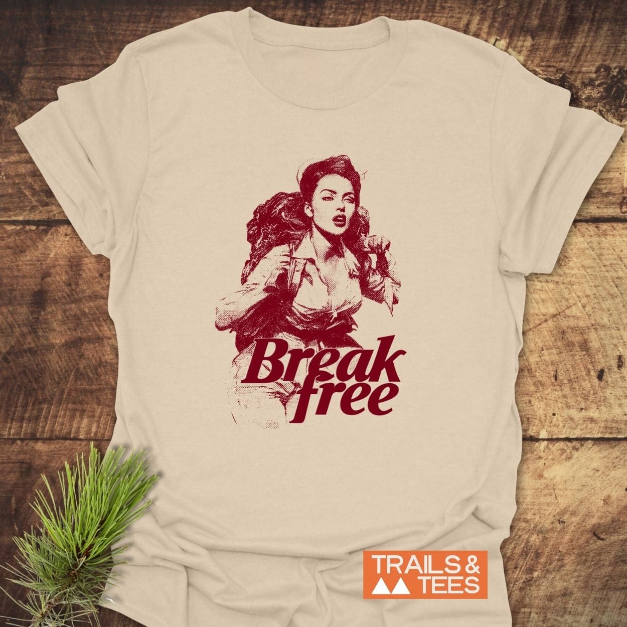 Break Free Hiking T-Shirt featuring a woman with a backpack illustration, Break free text, and TRAILS & TEES logo, designed for outdoor adventures.