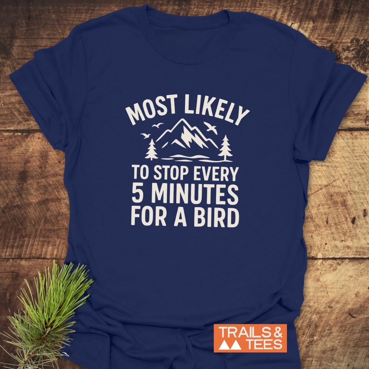 Most Likely Bird Watcher T-Shirt features outdoorsy graphic and slogan, navy blue with durable white print, highlighting comfort and adventure for outdoor enthusiasts.