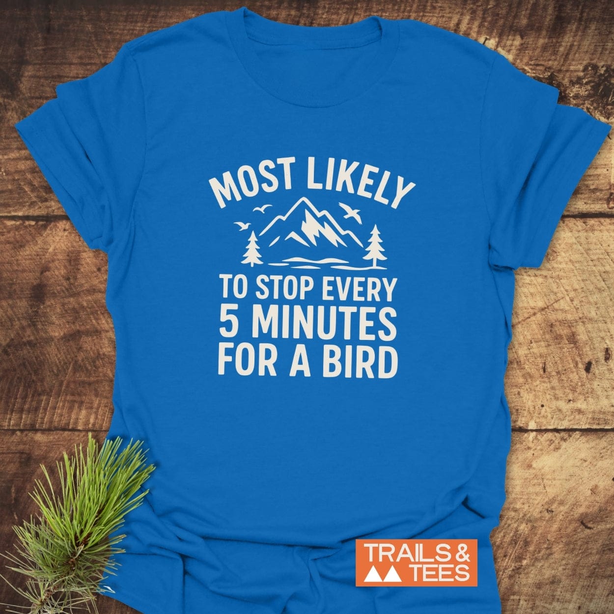 Most Likely Bird Watcher T-Shirt with mountain and bird graphic, Trail-tested, lightweight cotton, durable print. Featuring Trails & Tees logo, perfect for outdoor enthusiasts.