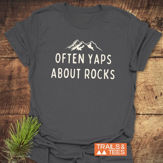 Often Yaps About Rocks T-Shirt featuring mountain peaks design; soft ring-spun cotton, pre-shrunk, durable print, eco-friendly production, perfect for outdoor enthusiasts.