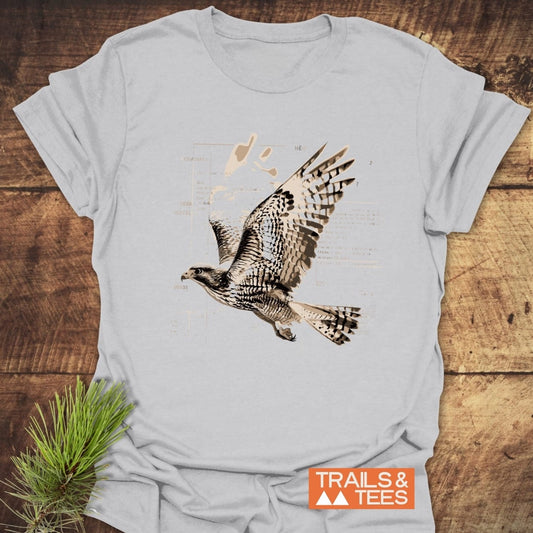 Bird Nerd T-Shirt featuring a flying raptor illustration, crafted from soft cotton, perfect for outdoor enthusiasts. Decoratively styled with a pine sprig.