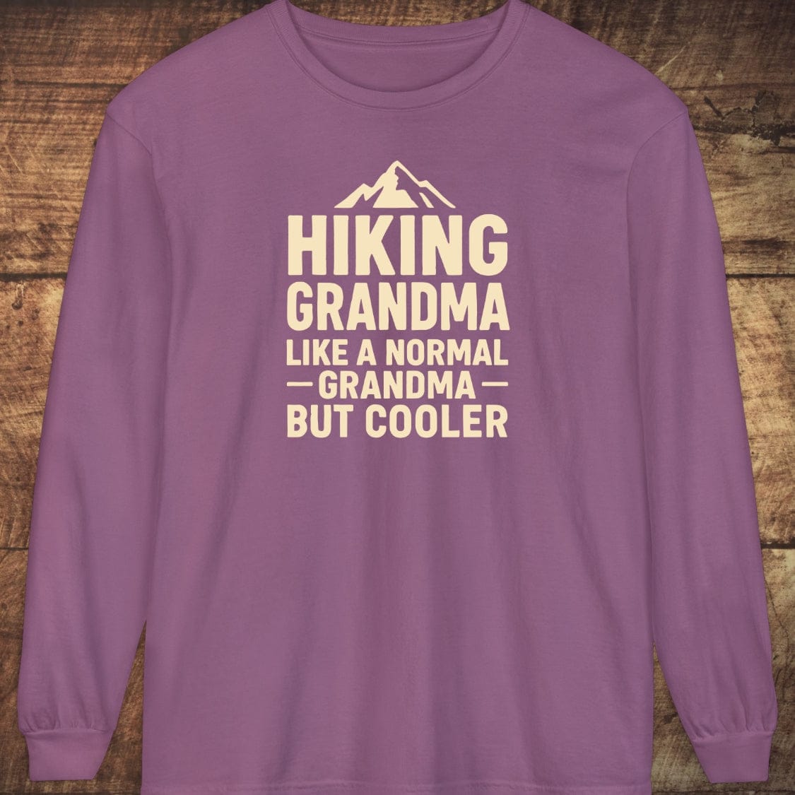 Hiking Grandma Comfort Colors Long-Sleeve Tee, featuring a mountain graphic and playful text on soft, garment-dyed cotton, offering a relaxed, stylish fit.