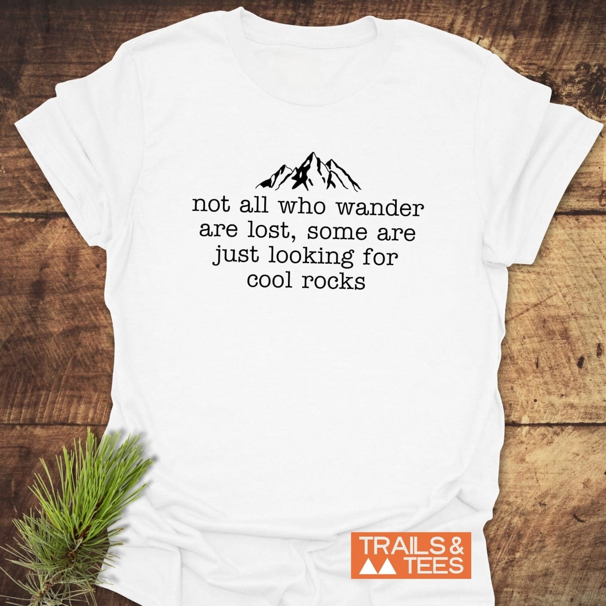 Looking For Cool Rocks T-Shirt featuring a mountain graphic and slogan on soft cotton, designed for comfort and adventure, branded with TRAILS & TEES.”