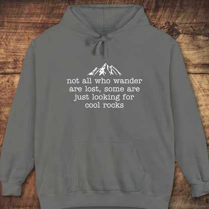 Looking For Cool Rocks Comfort Colors Hoodie with a white mountain graphic and quote, displayed on wood. Soft, unisex fit perfect for layering and adventure.