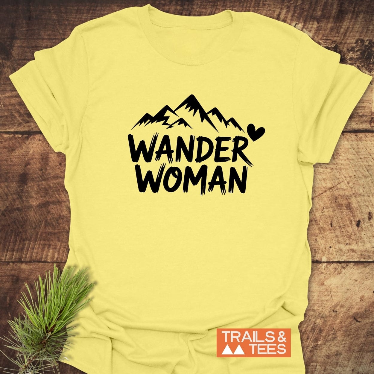 Wander Woman T-Shirt featuring a mountain silhouette and bold text, crafted from soft ring-spun cotton, ideal for outdoor enthusiasts.