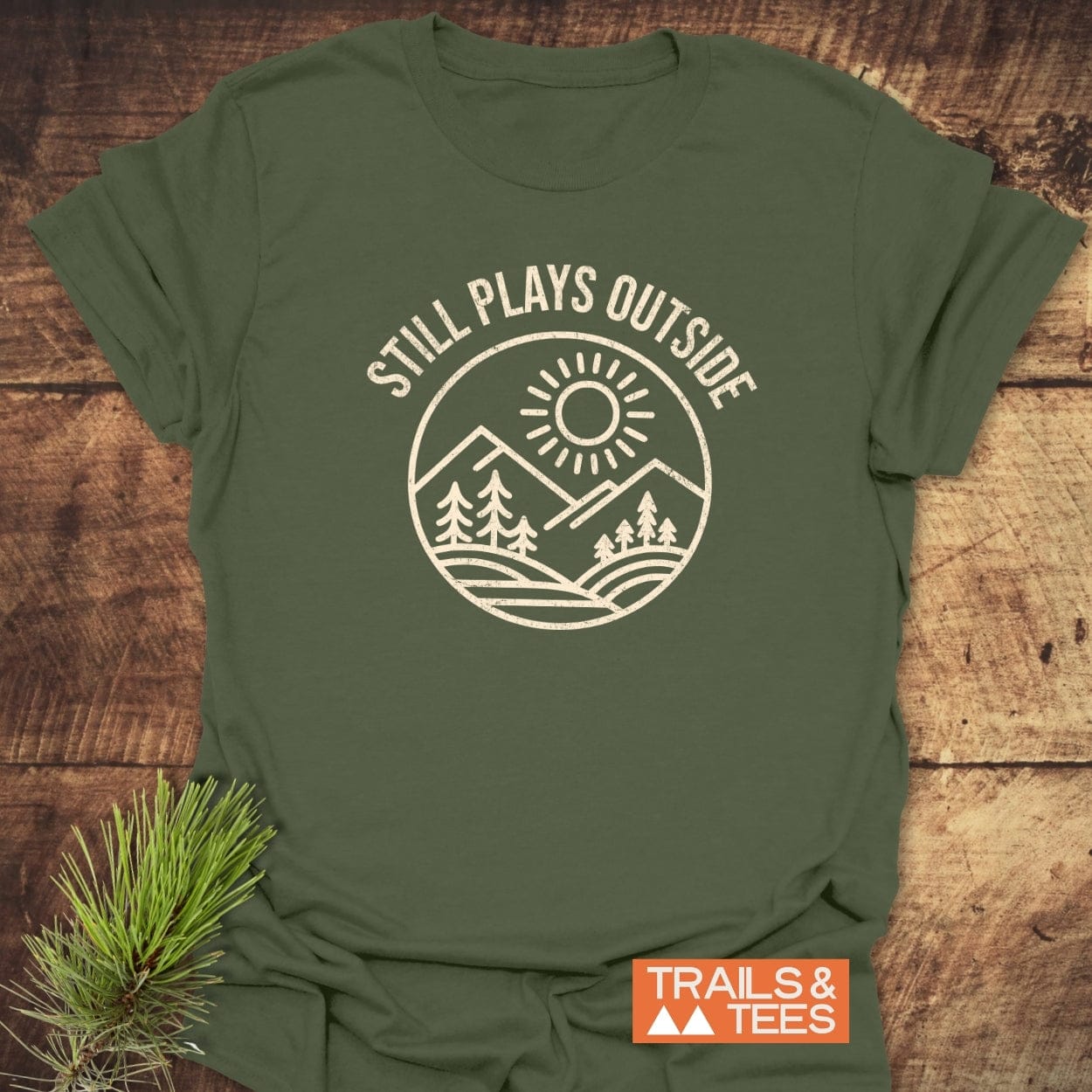 Forest-green Still Plays Outside T-shirt with a nature scene print, crafted from soft cotton, featuring a durable design for outdoor enthusiasts by Trails & Tees.