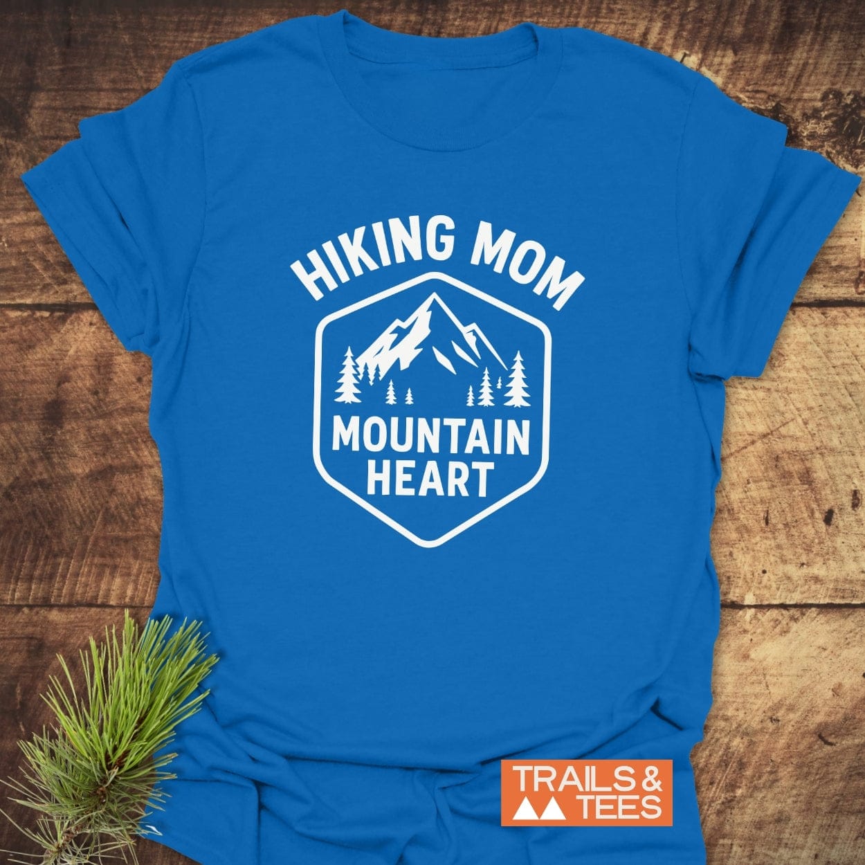 Hiking Mom Mountain Heart T-Shirt with mountain and pine graphic, featuring HIKING MOM text; crafted for comfort and durability, ideal for outdoor enthusiasts.