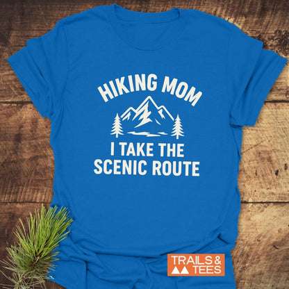 Hiking Mom, Scenic Route T-Shirt on rustic wood, features a mountain design with text. Made from soft cotton, pre-shrunk, durable prints, eco-friendly production.