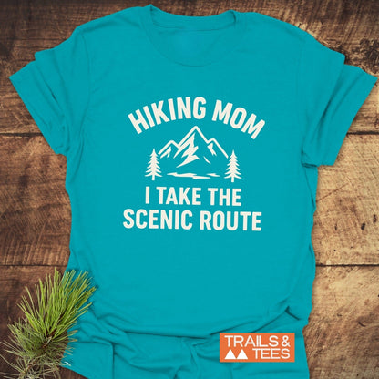 Hiking Mom, Scenic Route T-Shirt featuring a mountain, pine trees, and text, designed for comfort and durability with ring-spun cotton, pre-shrunk fit, and DTF prints.