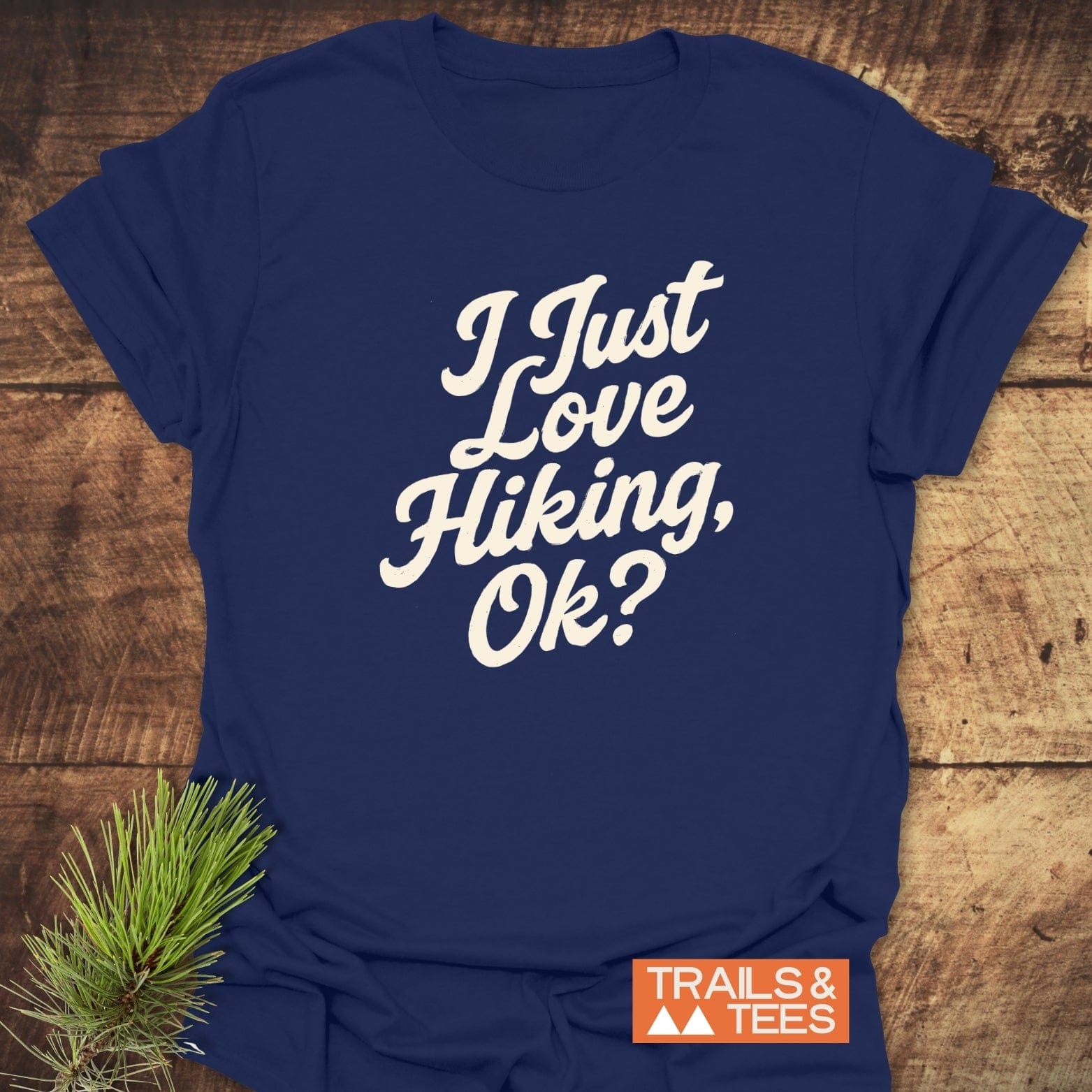 Navy T-shirt reading “I Just Love Hiking, Ok?” with pine sprig, showcasing durable, lightweight cotton for outdoor enthusiasts.