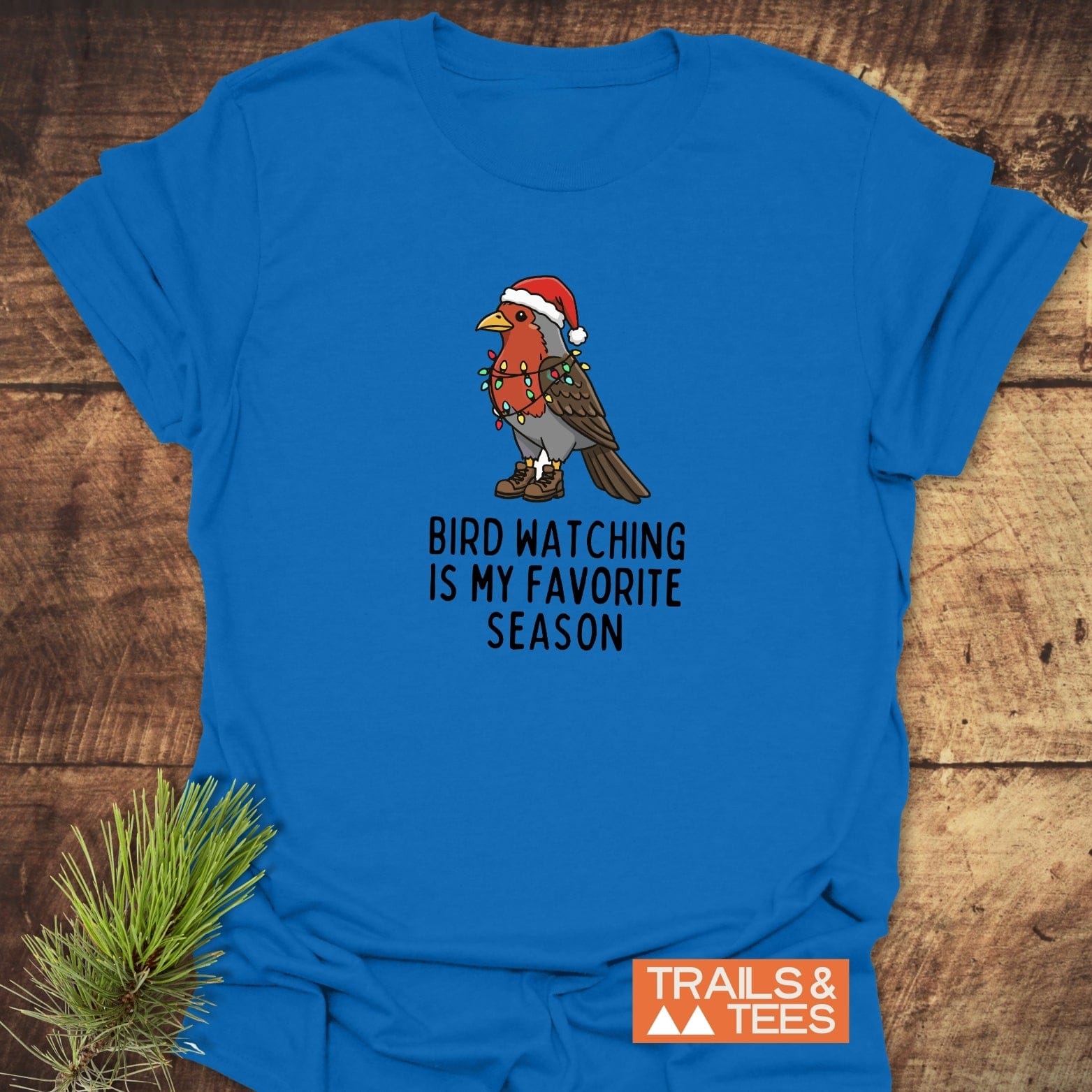 Bird Watching Season T-Shirt features a cartoon bird in a Santa hat with holiday lights on a soft, durable, ring-spun cotton tee.