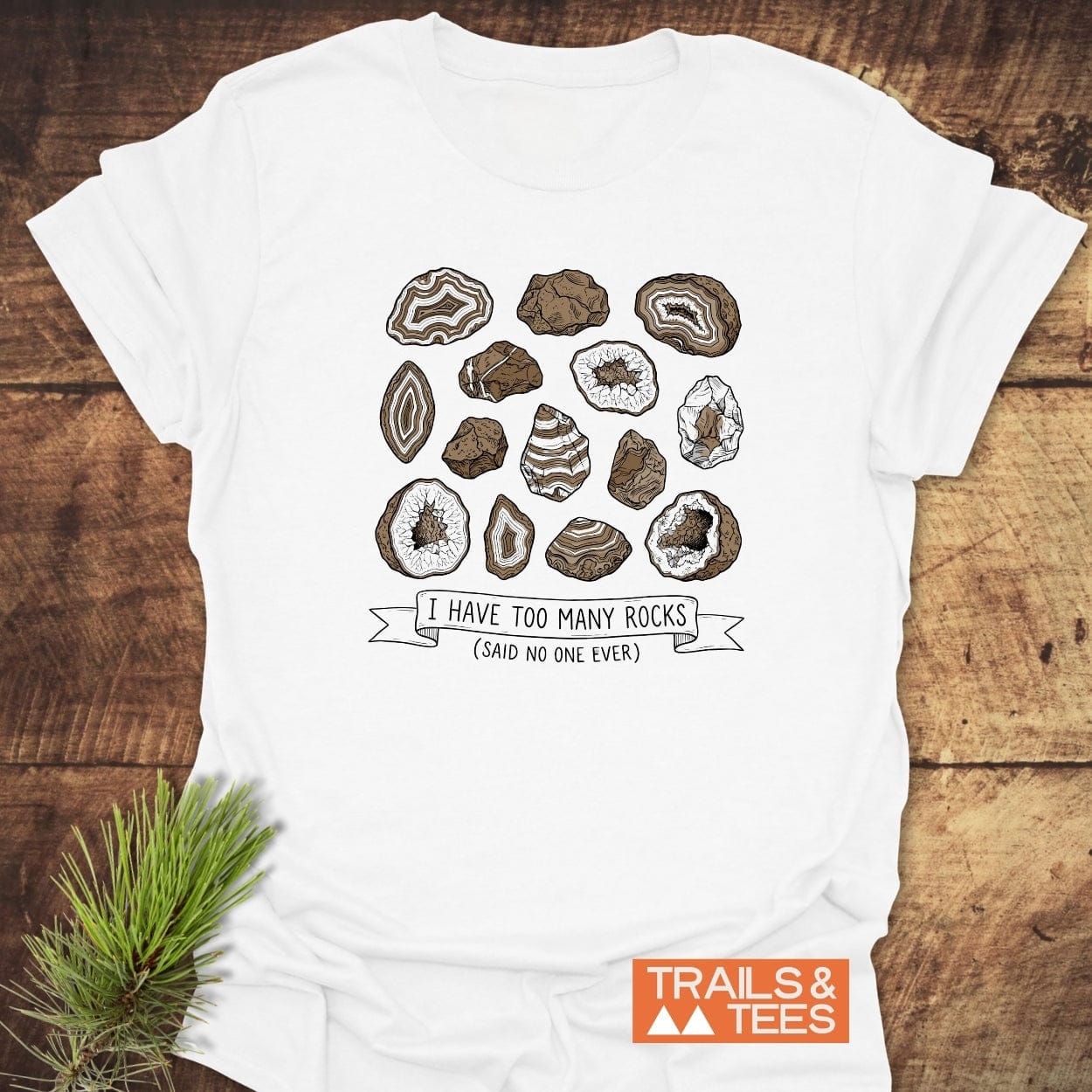 I Have Too Many Rocks T-Shirt features rock/geode illustrations and a witty slogan. Crafted from soft ring-spun cotton, perfect for outdoor enthusiasts. Brand: TRAILS & TEES.