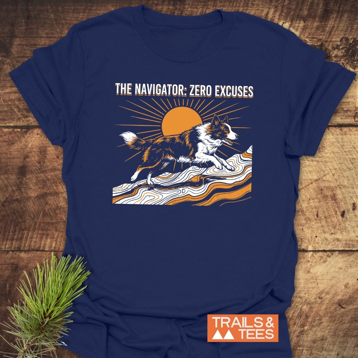 The Navigator Dog Lover T-Shirt features a border collie on a wavy landscape, sun backdrop, and ZERO EXCUSES slogan, embodying outdoor adventure spirit on soft, durable cotton.