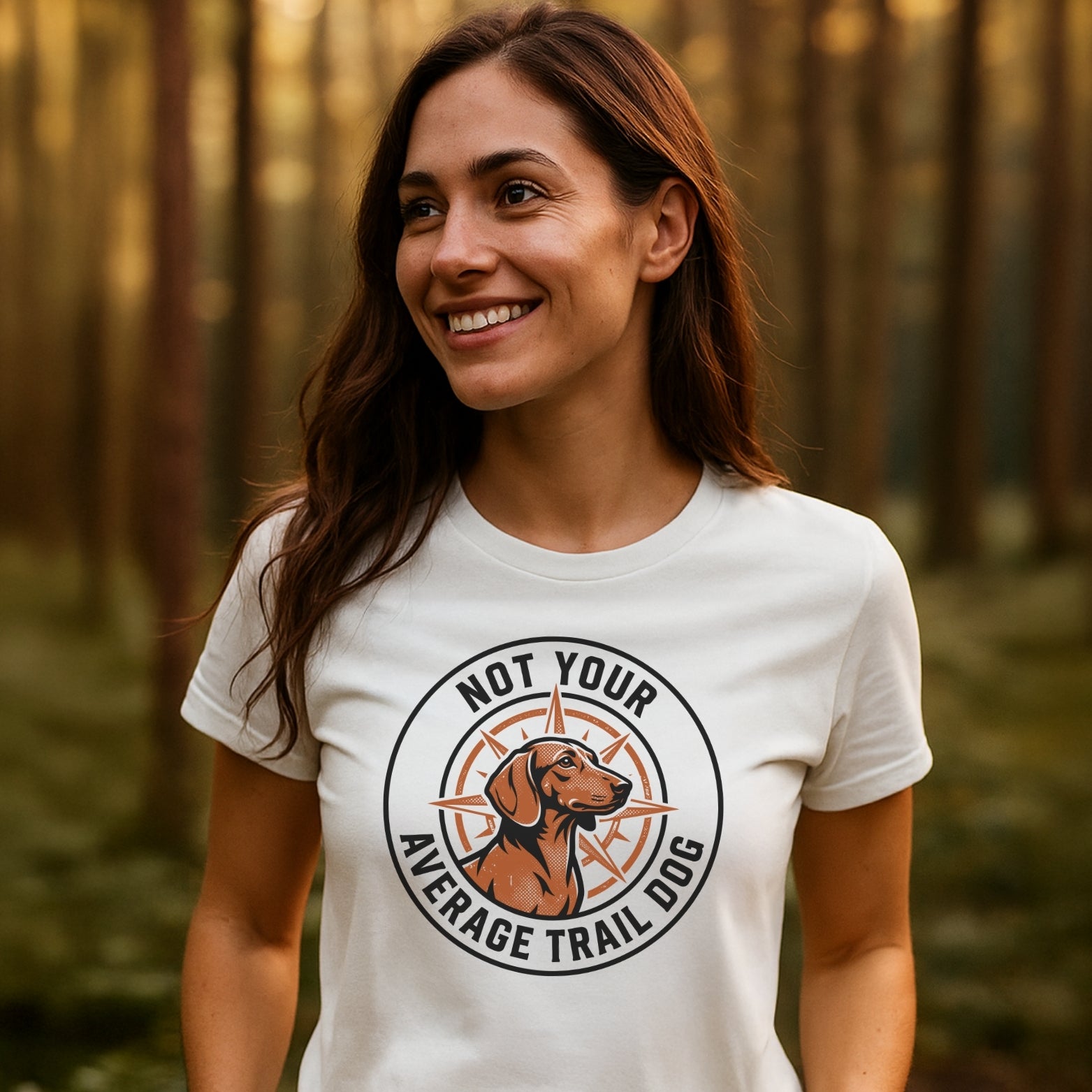 Person in forest wearing the Not Your Average Trail Dog Wiener T-Shirt, featuring a stylized dog head and compass logo. The shirt embodies trail-tested comfort with durable, fade-resistant prints.