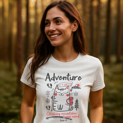 Adventure Cat Funny T-Shirt: A young woman in a forest wears a whimsical tee featuring a cartoon cat with a backpack, adventure elements, and inspirational phrases, celebrating imaginative outdoor journeys.