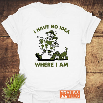 Lost Skeleton Hiker T-Shirt featuring a cartoon skeleton in hiking gear with a playful dog. Text above reads “I HAVE NO IDEA,” below “WHERE I AM,” showcasing outdoor humor and adventure spirit.