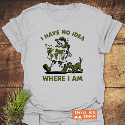 Lost Skeleton Hiker T-Shirt featuring a cartoon skeleton in hiking gear with a playful green dog. Bold text reads, “I HAVE NO IDEA WHERE I AM.” Perfect for adventure lovers.